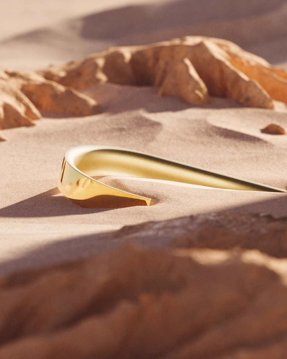 Gold BEYOND spout in desert sand