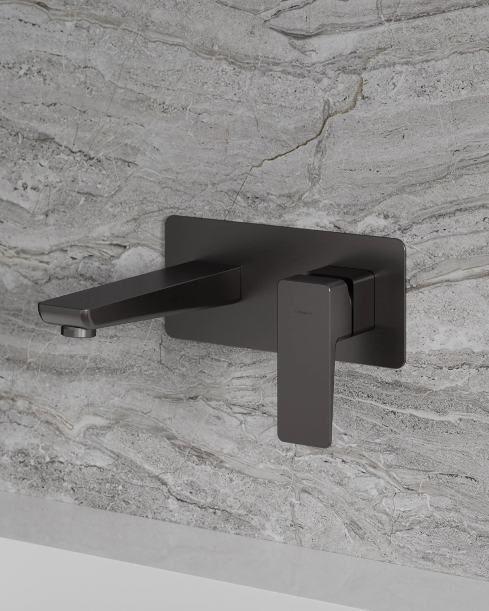 PARMA wall-mounted basin mixer in a graphite finish against stone