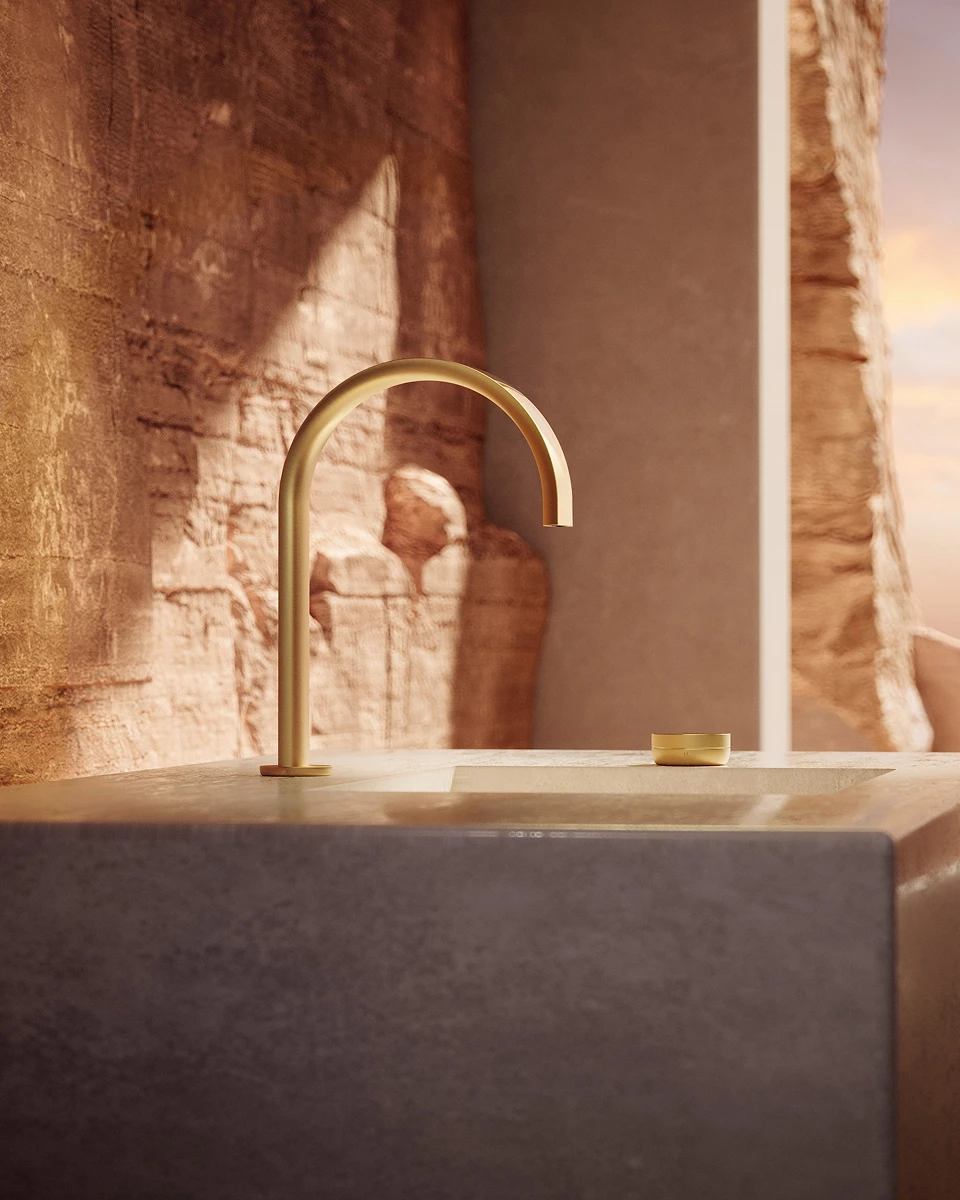 Gold BEYOND 2-hole basin mixer on a stone washbasin